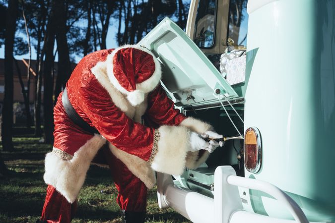 Santa Claus repairing old van