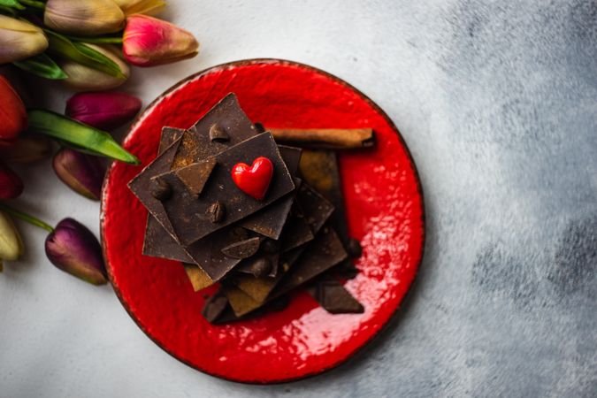 Chocolate with heart decorations and tulips