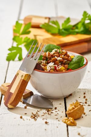 Bright vegetables with lentils and spinach in bowl