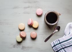 Spoon and napkin near coffee and macaroons