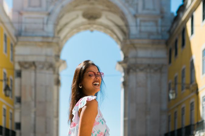 Woman showing standing near arch