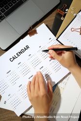 Top view of person reviewing a calendar bYZnd0