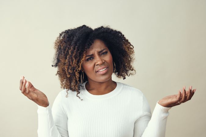 Black woman with both hands up in exasperation