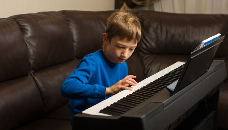 Focused Boy Playing Piano