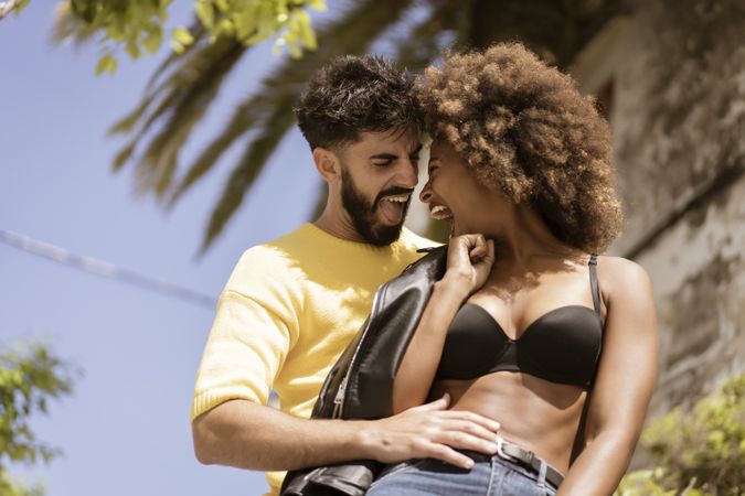 Happy couple flirting on street