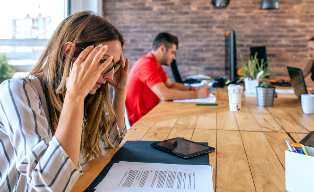 Stressed businesswoman with hands on head