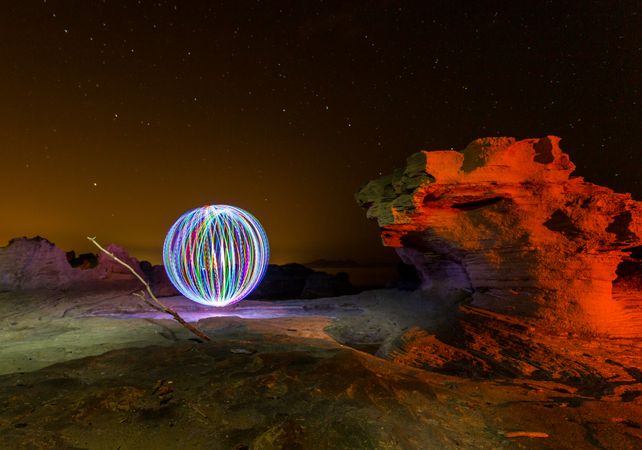 Abstract ball between stones at night