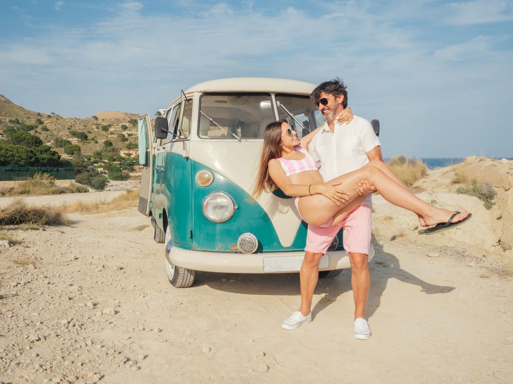 Man holding woman in hands and smiling