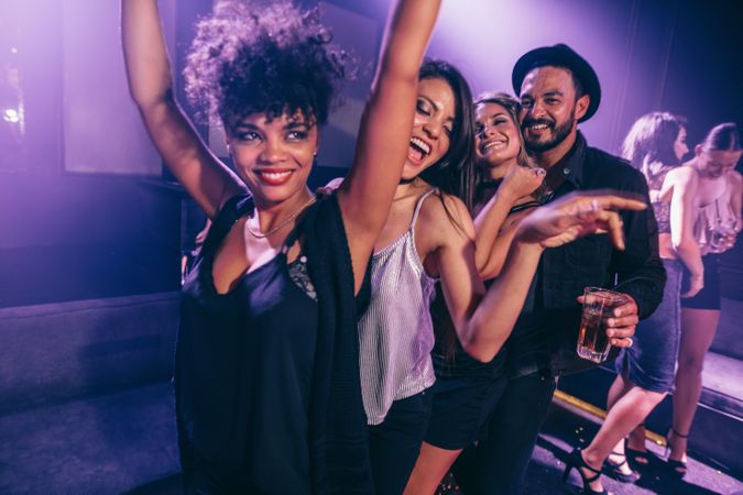 Group of friends dancing in nightclub