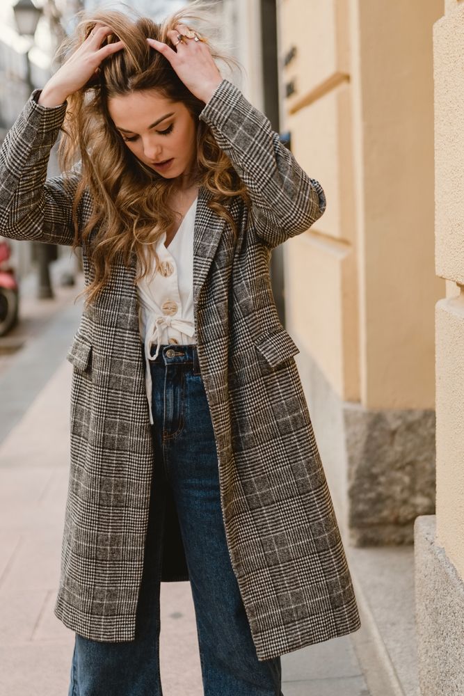 Woman leaning on wall on street