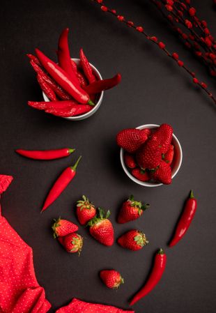 Cloth and branches near peppers and strawberries