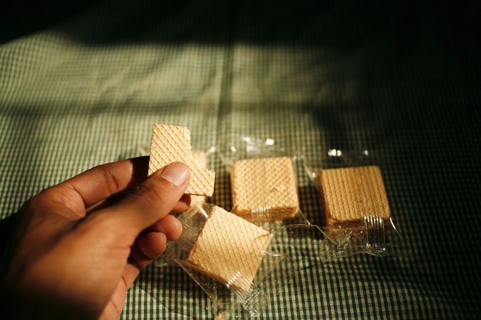 Hand with package of wafers