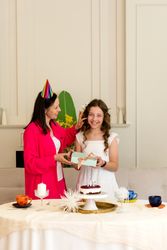 Birthday girl and mother share gift and smiles