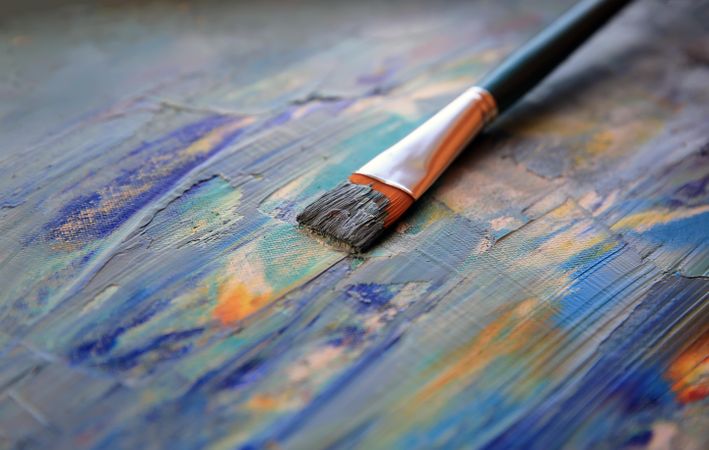 A paint brush resting on the canvas
