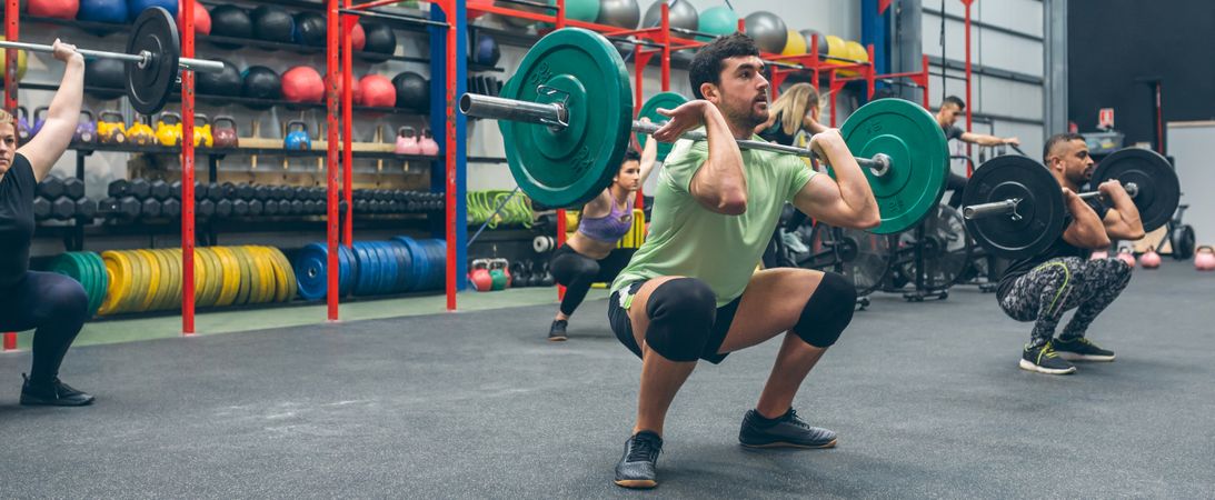 People practicing weightlifting in the gym