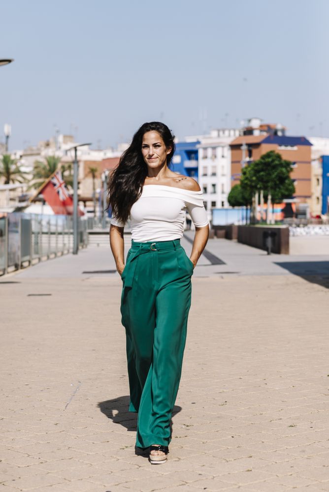 woman walking on street hands on pocket