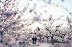 Shirtless man meditating in spring garden
