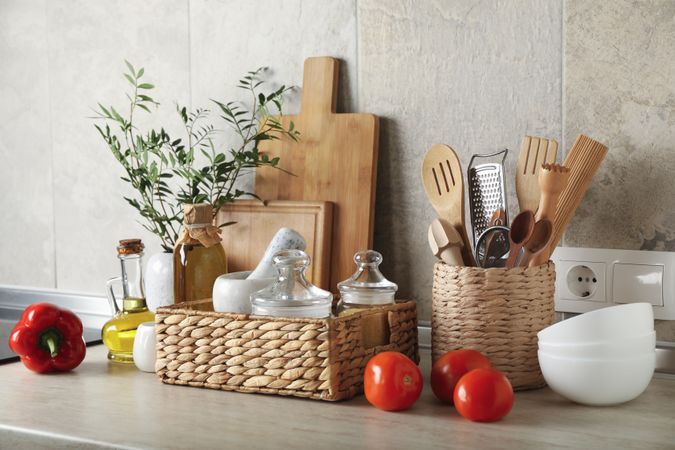 Kitchen table with different supplies and vase with plant
