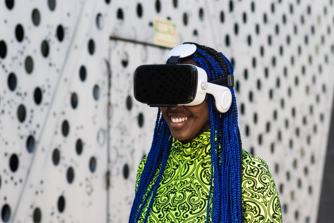 Black woman in VR headset in city