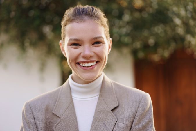 Cheerful Young Professional Dressed in a Stylish Blazer Radiating Positive Energy and Confidence