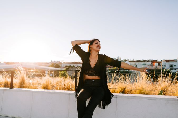 Trendy female standing on urban background