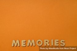The word “Memories” written in cork on dusty orange background, copy space 5RvrB5