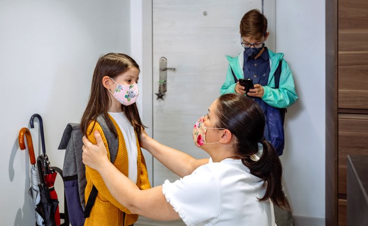 Mother advising daughter about coronavirus precautions