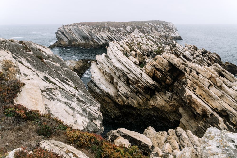 Rocky formations in the island of Baleal on the Atlantic coast in a foggy day. Peniche, Portugal