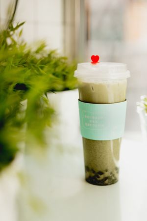 Cup of hot matcha tea in Asian cafe