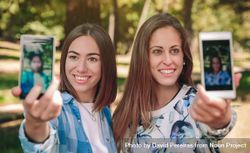 Women taking selfie photos with smartphones in nature bDjVOQ