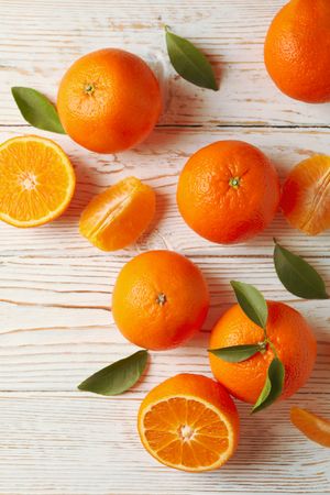 Ripe sweet mandarins on wooden background, top view