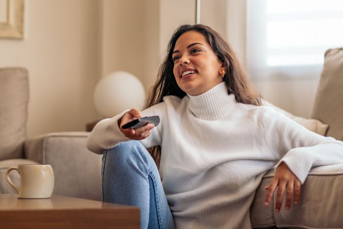 At-home entertainment: young woman enjoying television