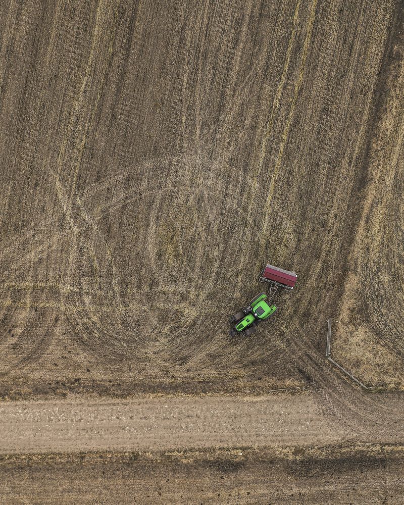 Aerial view of tractor working on farmland