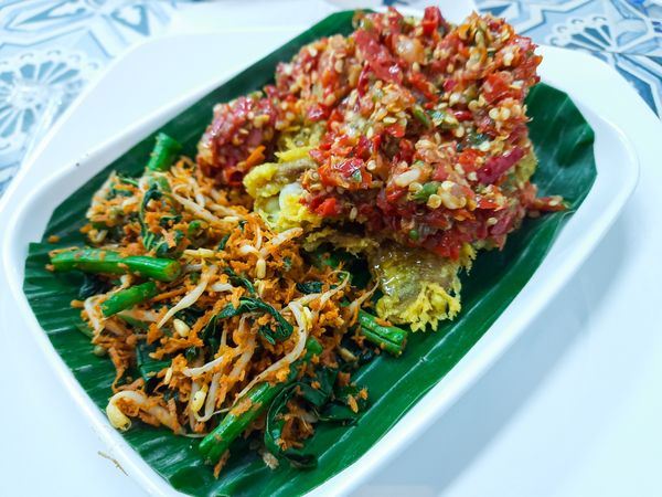 Sambal urap or grated coconut mixed with vegetables on a plate.