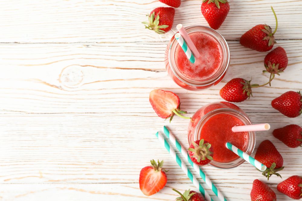 Composition with strawberry cocktails on wooden table. Summer berry
