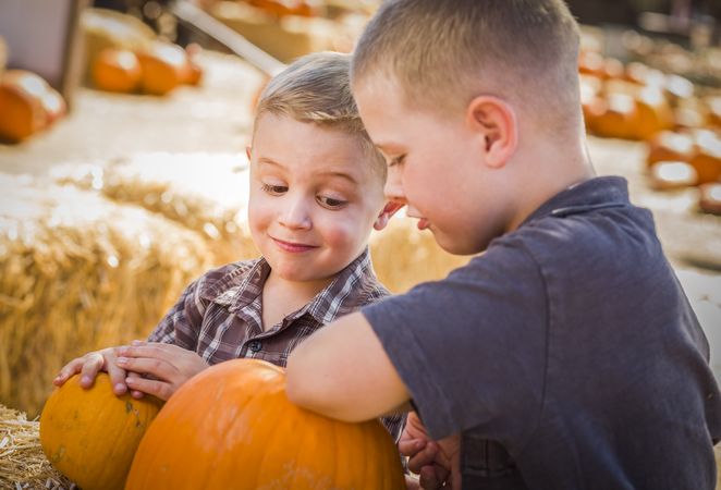Two Boys at the Pumpkin Patch Talking and Having Fun.