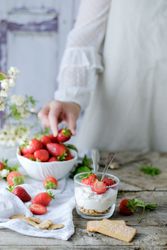 Confectioner cooking dessert of ripe strawberries