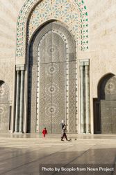 People walking beside Hassan II Mosque bYrJX0