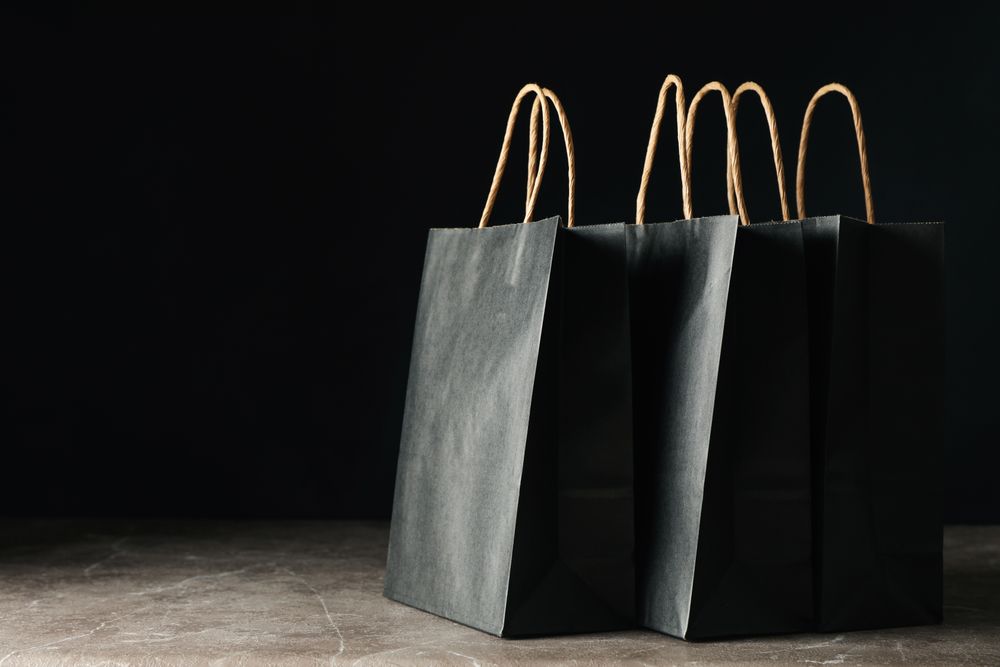 Paper bags against dark background, space for text