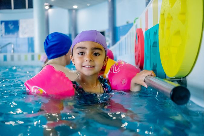 girl with water wings in swimming pool
