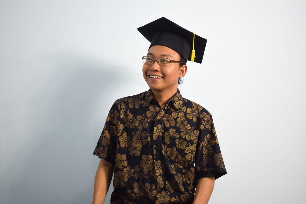 Happy graduate in studio shoot