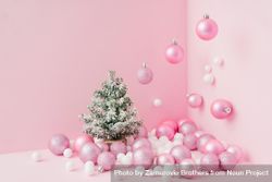 Baubles in a variety of pink shades in corner of pink room with Christmas tree 0Pg8mb