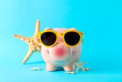 Happy piggy bank with sunglasses and starfishes on color background, space for text. Finance, saving money
