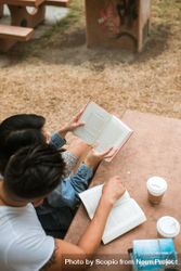 Top view of man and woman reading books sitting outdoor 0yQ2L0