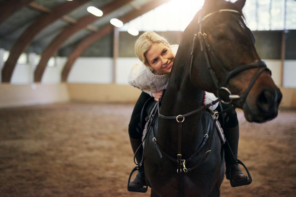 Young female jockey training with her horse
