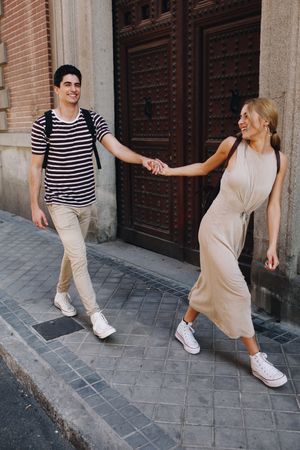 Happy couple having fun while walking in town