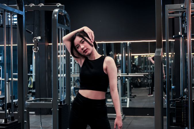 Young Woman Doing Exercise before Workout at the Gym