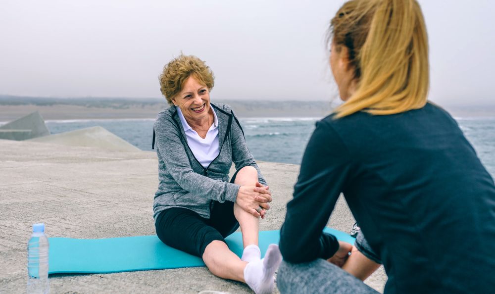 Mature sportswoman laughing with young woman