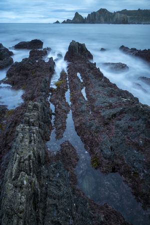Foggy landscape of Playa de Gueirua rock seashore