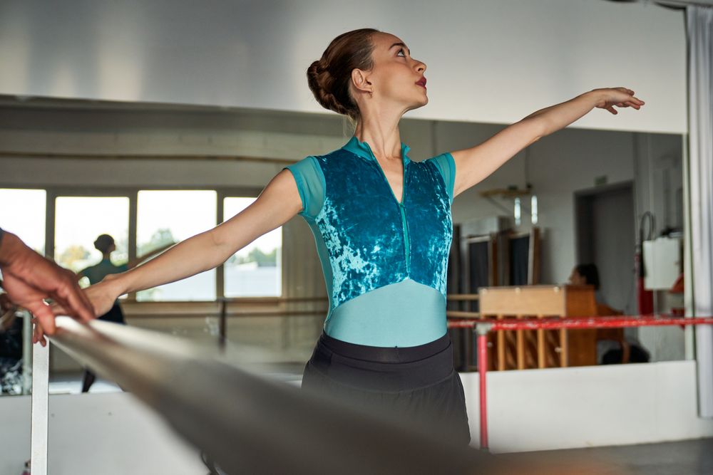 Ballet dancer warming up and dancing at a dance academy
